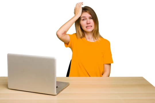 Young caucasian woman in a workplace working with a laptop isolated forgetting something, slapping forehead with palm and closing eyes. - Powered by Adobe