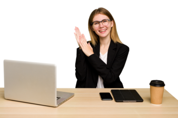 Young business caucasian woman working on her workplace cutout isolated feeling energetic and comfortable, rubbing hands confident.