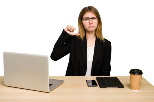 Young business caucasian woman working on her workplace cutout isolated showing a dislike gesture, thumbs down. Disagreement concept.