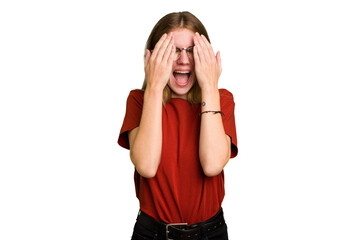 Young caucasian woman isolated having fun covering half of face with palm.