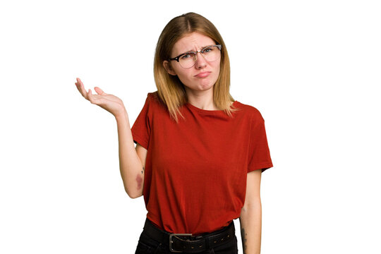 Young caucasian woman isolated doubting and shrugging shoulders in questioning gesture.