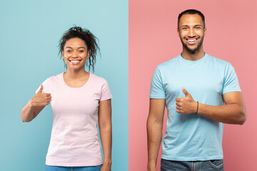 Excited african american spouses showing their thumbs up and smiling on pink and blue studio background
