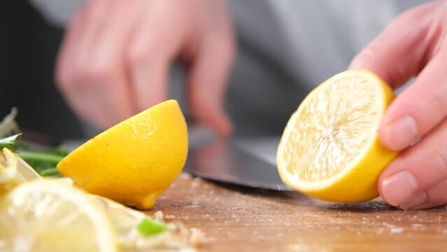 chef cutting yellow lemon