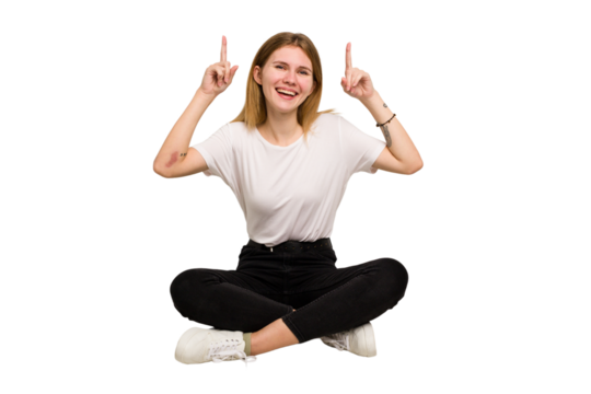 Young caucasian woman sitting on the floor cutout isolated