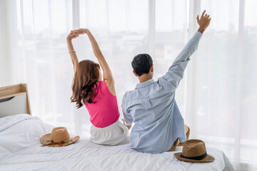 Fototapeta premium Asian couples are preparing to travel together both domestically and internationally. Have a good travel plan through the Internet. Both of them are happy and excited about going on a trip together.