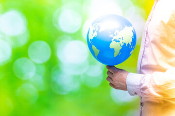 ESG concept, Environmental, Social, governance, Value-based business, Sustainable development, Empty space, Businessman holding a planet earth balloon in his hands