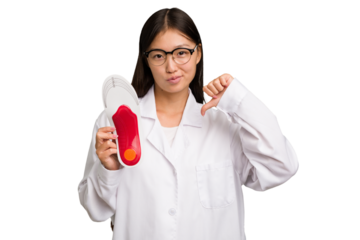 Young asian chiropodist holding a insoles for shoes isolated feels proud and self confident, example to follow.