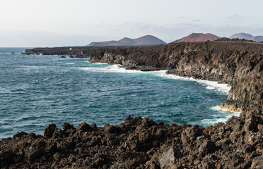 Breathtaking view from the coast overlooking the sea. Crystal clear sea, wind and waves crashing on the rocks.
Lanzarote, Canary Island, Spain.