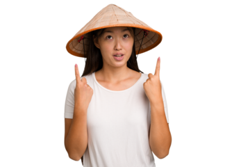 Young asian woman wearing a Vietnamese hat isolated pointing upside with opened mouth.
