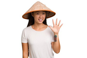 Young asian woman wearing a Vietnamese hat isolated smiling cheerful showing number five with...