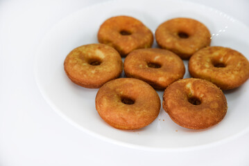 Round shortbread cookies on a plate. Soft sweet cake on a white background. A sweet snack.
