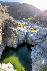 Aerial view of Zorro Canyon Waterfall in the ecological ranch Sol De Mayo on a sunny day in Santiago, Baja California Sur, Mexico