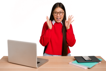 Young student asian woman in a workplace with a laptop isolated celebrating a victory or success, he is surprised and shocked.