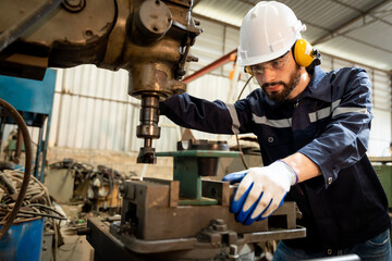 Team of engineers practicing maintenance Taking care and practicing maintenance of old machines in the factory so that they can be used continuously.