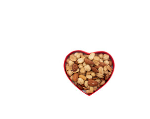 mix nut in red heart shape box on white background, Valentine's Day or birthday concept, copy space area, top view 