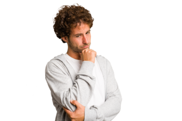 Young curly smart caucasian man cut out isolated looking sideways with doubtful and skeptical expression.
