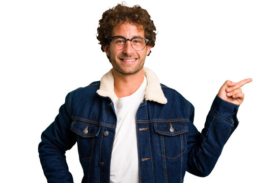 Young curly smart caucasian man cut out isolated smiling cheerfully pointing with forefinger away.