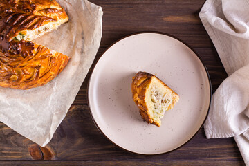 A piece of savory pie with chicken, potatoes and rice on a plate. Homemade pastries. Top view © elenarui