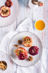 Homemade baked apples with walnuts and honey on the table. Top and vertical view