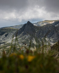 Sharp peak steep top of a rocky mountain. Sharp apex dramatic sky mountains