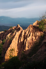 Orage sandstone sharp peak cliff during golden hour sunset 