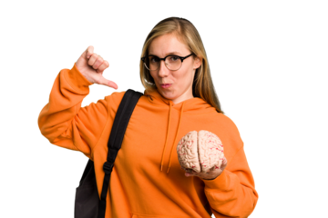 Young student caucasian woman holding a brain isolated feels proud and self confident, example to follow.