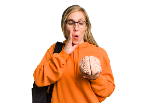 Young student caucasian woman holding a brain isolated is saying a secret hot braking news and looking aside