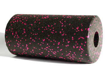 A black pink massage foam roller isolated on a white background. Close-up. Foam rolling is a self...