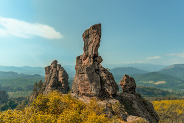 Fototapeta na wymiar Sandstone rocky peaks, rock boulder Belogradchik rocks Bulgaria, clear sky, colorful forest landscape