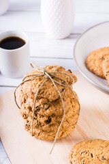 Oatmeal cookies with raisins on the board. Home made pastries. Vertical view