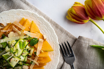Refreshing and healthy salad with shaved zucchini and sliced melon. Garnished with fresh mint,...