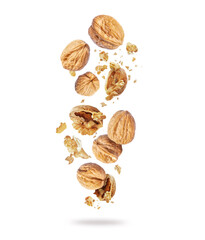 Whole and cracked walnuts close-up in the air on a white background