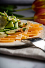Refreshing and healthy salad with shaved zucchini and sliced melon. Garnished with fresh mint, almonds, and parmesan cheese.