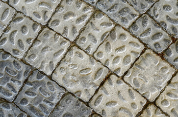 Close-up of dark gray and light gray paving slabs with oval bulges.background texture paving slabs 