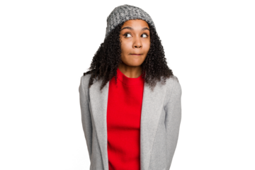Young african american woman wearing winter jacket isolated confused, feels doubtful and unsure.