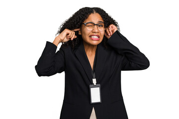 Young african american business woman with ID card isolated covering ears with hands.