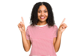 Young african american woman with curly hair cut out isolated indicates with both fore fingers up...