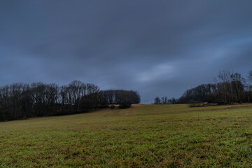Fototapeta premium Field near Nemci small village in Ceske Stredohori mountains in winter day