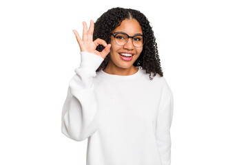 Young african american woman with curly hair cut out isolated cheerful and confident showing ok...