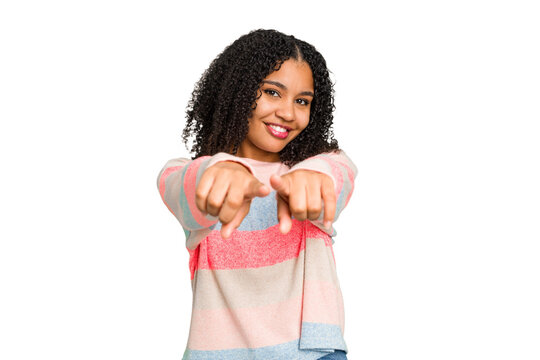 Young african american woman with curly hair cut out isolated pointing to front with fingers.