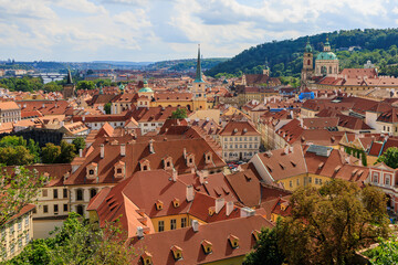 Fototapeta na wymiar Roofs of houses and a view of the city of Prague. Background with selective focus and copy space