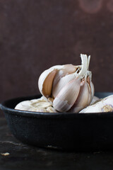 Garlic bulbs  in cast iron skillet , garlic,unpeeled raw garlic, Allium sativum