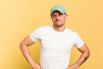 Young caucasian handsome man isolated on yellow background confused, feels doubtful and unsure.