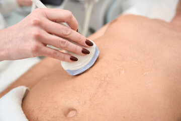 Doctor conducts a comprehensive ultrasound examination of a middle-aged man