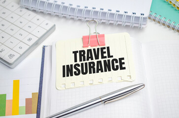 travel insurance word alphabet letters on white notebook