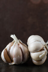 Garlic bulbs on dark wood table, garlic,unpeeled raw garlic, Allium sativum