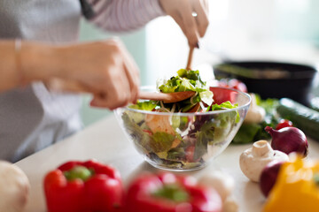 Female hands making fresh vegetable salad, preparing meal at home