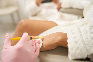 Close up photo of doctor doing injections for patient