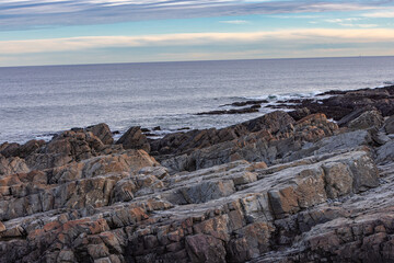 Oblique Cliffs Merging Into The Ocean. Cliff Beach With Ocean Waters And The Sky Merging At The Horizon. 