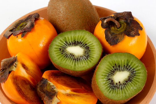 Clay trough with persimmons and kiwis